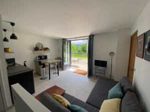 a living room with a couch and a table at Le Narlay in Le Frasnois