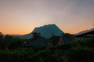 a mountain in the distance with a sunset in the background at The CAMPIAN in Chiang Dao