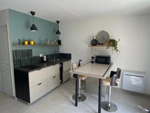 a kitchen with a table and a counter top at Le Narlay in Le Frasnois +15 photos