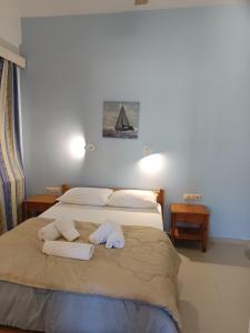 a bedroom with a bed with two towels on it at Maria's Apartments in Kalyves
