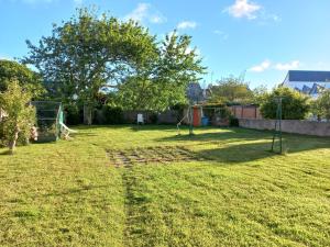 a yard with a swing set in the grass at Maison de Crozon in Crozon