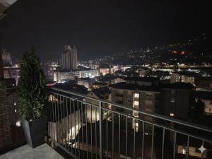 a view of a city at night from a balcony at Narcis in Užice