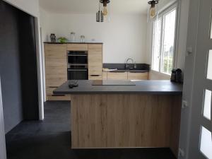 a kitchen with a large island in the middle at Maison de Crozon in Crozon