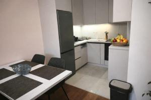a kitchen with a table with a bowl of fruit on it at Narcis in Užice