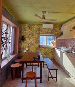 a kitchen with a wooden table and a dining room at SoSi Stay in Seoul