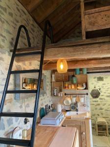a small kitchen with a ladder in a room at La Loge de Rose in Peyrelade