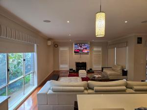 a living room with a couch and a tv at River view in Shepparton
