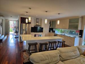 a kitchen with a counter and bar with stools at River view in Shepparton