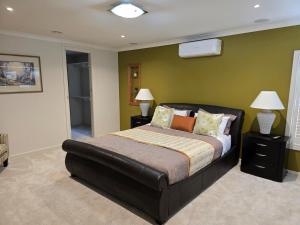 a bedroom with a large bed and two lamps at River view in Shepparton