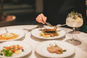 a person eating food on a table with plates of food at Kyoto Century Hotel in Kyoto