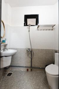a bathroom with a toilet and a sink at BeYouth Hotel Dalat Valley View in Da Lat