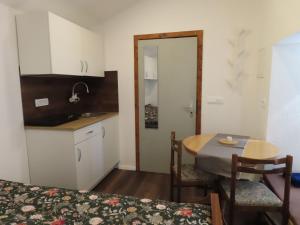 a room with a table and a kitchen with a table and chairs at The Ramsons - Čemaž Glamping in Železniki