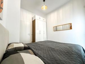 a bedroom with a bed and a mirror on the wall at 214 The Coastal Nest in Durrës