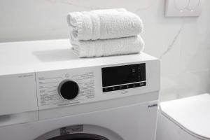 a stack of towels on top of a washing machine at 214 The Coastal Nest in Durrës