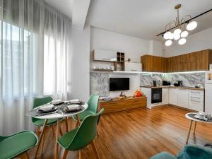 a living room with a table and chairs and a kitchen at 214 The Coastal Nest in Durrës