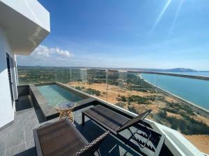 a view of the ocean from a house balcony at The Seafront Condotel - Apec Mandala in Mui Ne