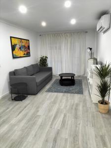 a living room with a couch and a table at SUNSHINE GROUP in Málaga