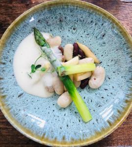 a plate of food with vegetables on a table at Le Refuge de Castagnols in Vialas