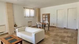 a living room with a white couch and a table at Antica dimora "Nicole e Cristiano" in Otranto