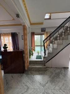 a staircase in a living room with a stair case at The Basecamp Dorm in Siliguri +31 photos