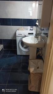 a bathroom with a sink and a washing machine at Margerita in Mytilene +22 photos