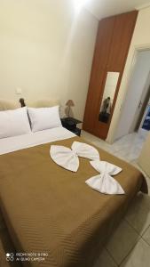 a bedroom with a bed with two white towels on it at Margerita in Mytilene