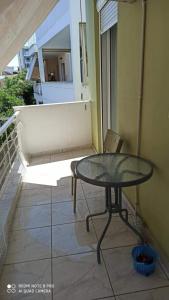 a table and a chair on a balcony at Margerita in Mytilene
