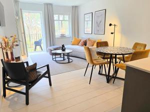 a living room with a couch and a table at Ferienwohnung Lieblingssuite am Strand in Ahlbeck