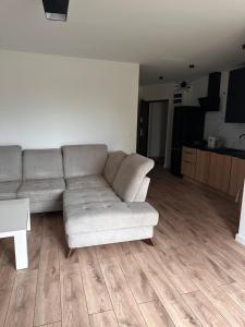 a living room with a couch and a table at Apartament Ełcka 2- Mazury in Orzysz