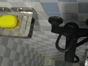 a yellow hat sitting on a toilet in a bathroom at BRACCK Suites in Nakwero +9 photos