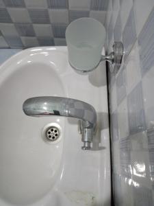 a sink with a faucet in a bathroom at BRACCK Suites in Nakwero