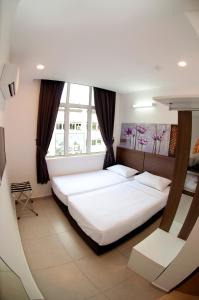 Postel nebo postele na pokoji v ubytování Hotel Cheqinn