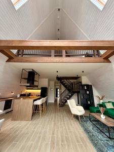 a living room with a loft with a staircase at Colina Monteoru in Sărata-Monteoru