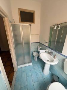 a bathroom with a shower and a sink and a toilet at Casa dei mille in Castelsardo