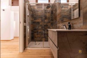a shower with a glass door in a bathroom at Identity By Rentbase in Cefalù +44 photos