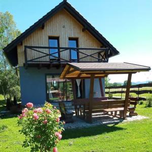 a house with a bench and a gazebo at Luma Hause & Spa Karkonosze in Wojcieszyce