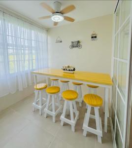 a kitchen with a wooden table and stools at Casa Augusto in Santo Tomas