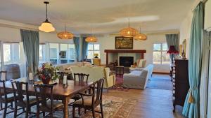 a living room with a table and a dining room at The Edge Mountain Retreat in Hogsback