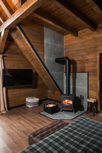 a bedroom with a stove in a room with wood at Cervus Magura in Măgura +210 photos