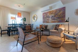 a living room with a couch and a table at Quinta do Pedro in Luz de Tavira