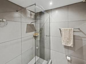 a shower with a glass door in a bathroom at Casa Solis at Wild Olive in Windhoek +18 photos