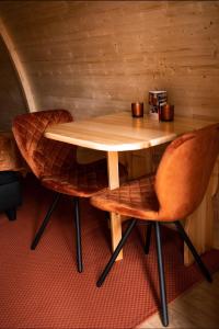 a wooden table and two chairs in a room at Parc Boulée in Ven-Zelderheide +14 photos