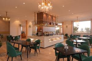 a restaurant with tables and chairs and a kitchen at Rung La Kim Resort in Da Lat +150 photos
