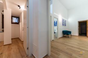 a hallway with white walls and wooden floors at Identity By Rentbase in Cefalù
