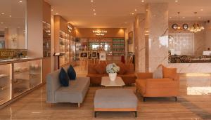a lobby with couches and chairs in a store at Rung La Kim Resort in Da Lat