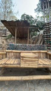 a wooden bench with a flower arrangement on it at Nepal VaNaVaS Retreat in Changunarayan +12 photos