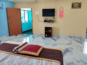 a bedroom with a marble floor with a bed at Auro Delight - Near Auroville in Pondicherry in Villupuram