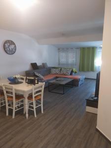 a living room with a couch and a table at Apartmani PERLA 55 in Poreč