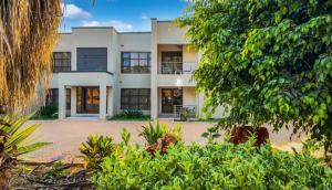 an exterior view of a building with trees at Sable Suites B2, 2 & 3 Bed Apartments in Kabulonga in Lusaka