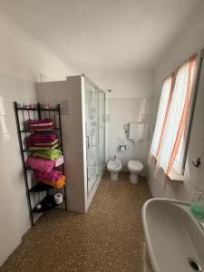 a bathroom with a shower and a toilet and a sink at Appartamento LUNA in Mele +16 photos